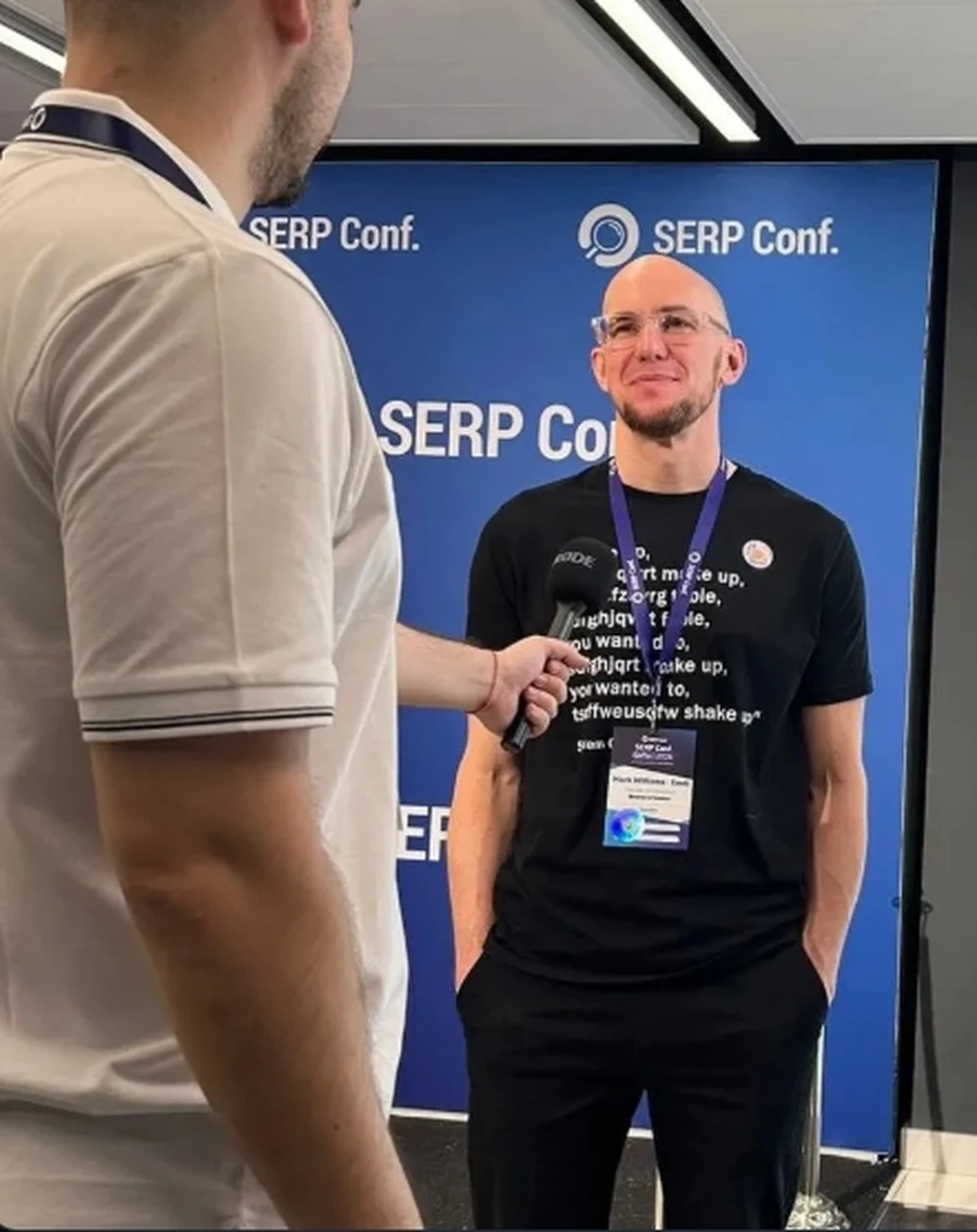Mark Williams-Cook being interviewed on stage with a microphone